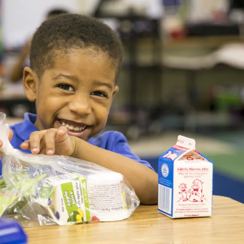 Boy eating breakfast at school